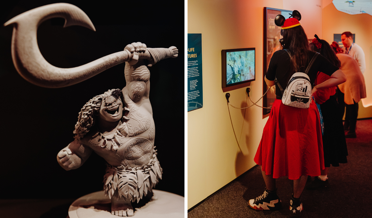 Maquette of Maui from Moana and a woman listening on headphones at Disney100: The Exhibition, ExCeL London